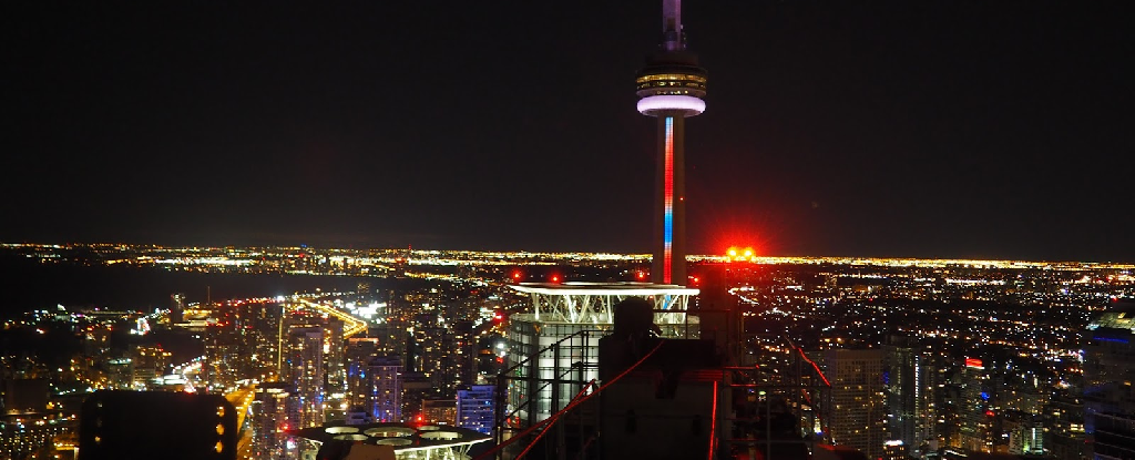 Picture from atop a tall construction crane in Toronto, with the CN tower in the background. 
